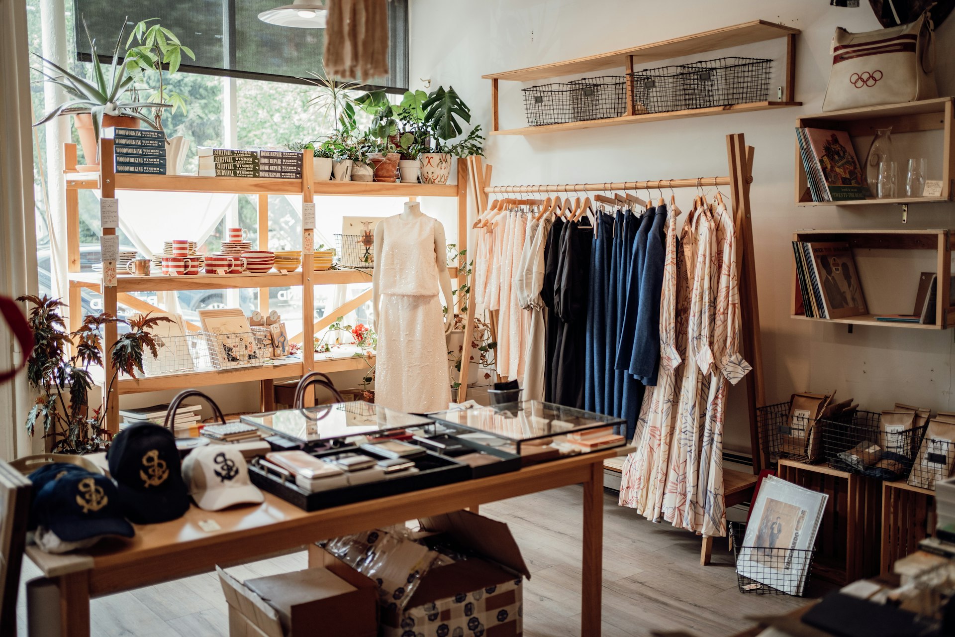A clothing store with clothes and hats on display