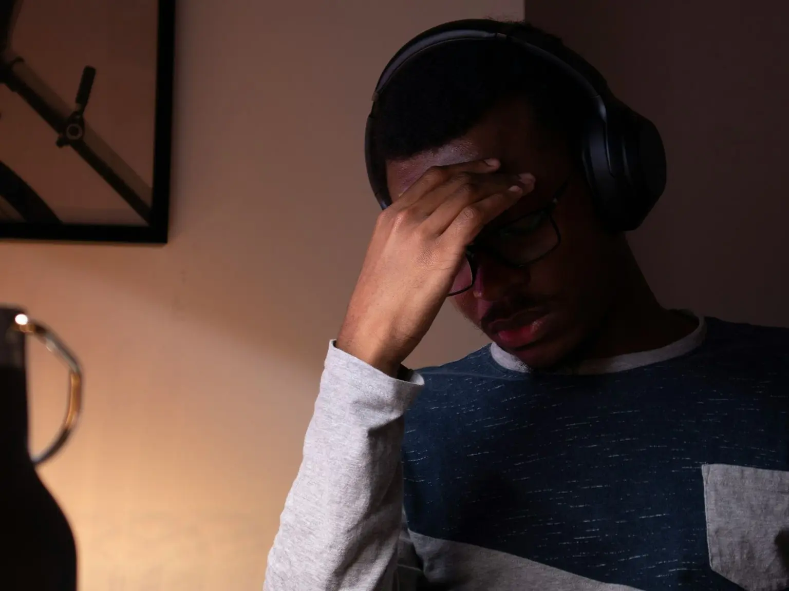 woman in gray sweater covering her face