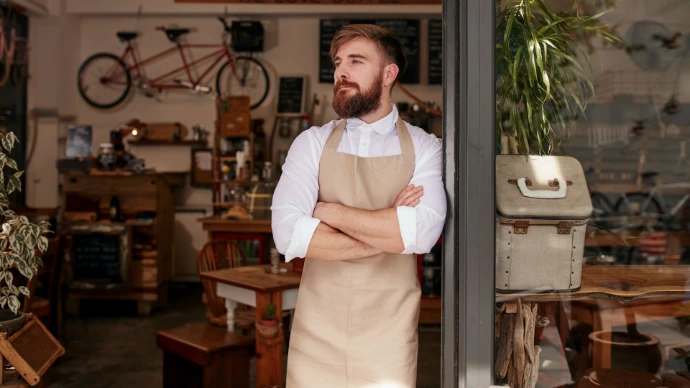 store owner looking left outside his store