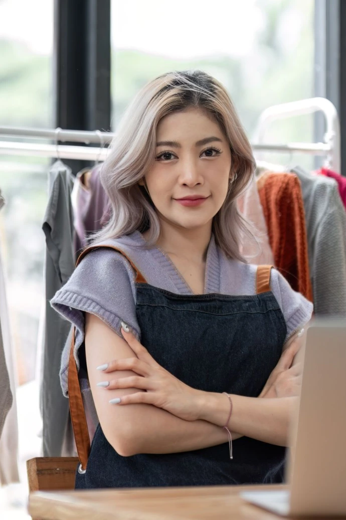 Woman Entrepreneur with Clothing Rack in Studio