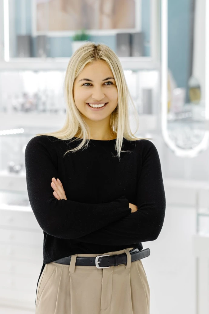 Smiling shop assistant showing jewelry in a jewelry store