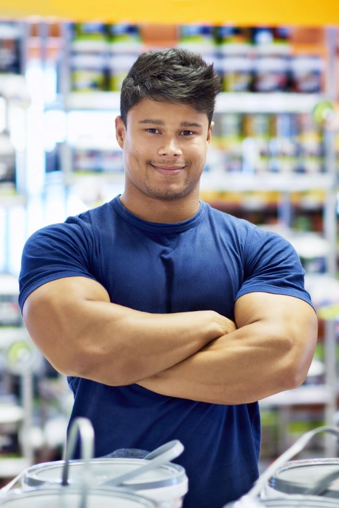 Confident Man with Muscular Build Poses Indoors