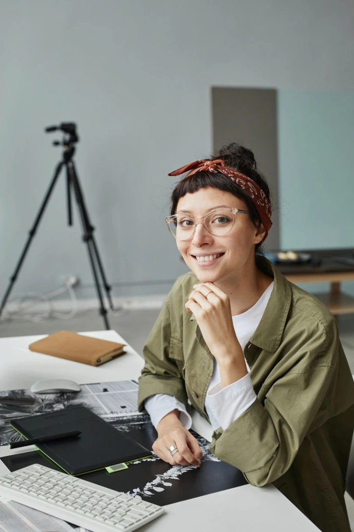 Smiling Female Photographer at Workplace in Studio