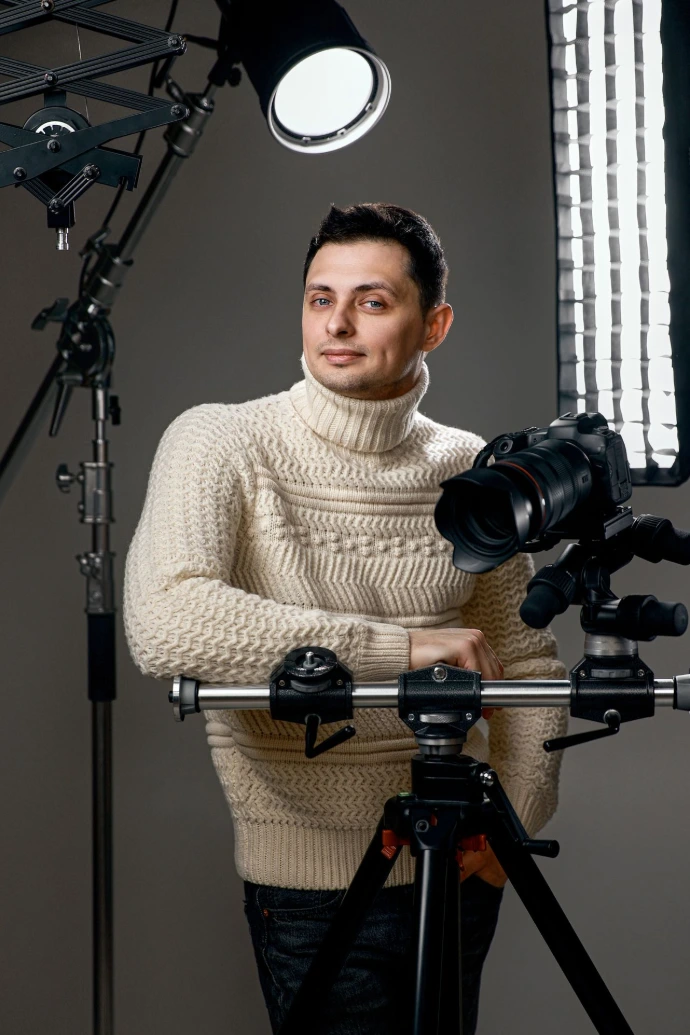 Photographer Posing with Camera and Professional Studio Lighting